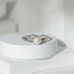 Product Details Make a statement with the stunning Freshwater Pearl Ring, a classic design featuring a round-cut Freshwater Pearl delicately set in a prong setting and accented with sparkling Diamond. A perfect symbol of commitment and love, this Freshwater Pearl Ring is a great choice to celebrate your special bond with your partner while highlighting your unique sense of style. Product Information SKU SHP-RINGS072210057 Weight 2.00 gm (Approximate) FRESHWATER PEARL INFORMATION No.of Stones 1 P Silver Solitaire Pearl Ring In Fine Jewelry Style, Elegant White Gold Polished Pearl Ring, White Solitaire Pearl Ring Fine Jewelry, Diamond Pearl Ring With Polished Finish, Solitaire Pearl Ring, Fine Jewelry, Pearl Engagement Ring, Freshwater Pearl Ring, Sparkling Diamond, Ring With Diamond