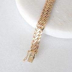 This stunning vintage bracelet crafted in 14k yellow gold and is perfect to wear on its own or layered with other bracelets! Metal: Genuine 14k yellow gold Closure: Box with clip Width: 7.8 mm Length: 7.5 inches Weight: 8.1 grams Please allow up to 5 business days for processing. Currently only shipping within Canada and the USA.  | c u r a t e d | Visit our website for curated and modern pieces  https://www.menkduke.com | f a c e b o o k | Follow us on Facebook for new item announcements and di Antique Gold Bracelets For Anniversary, Antique Gold Bracelet Strap Jewelry, Timeless Gold Bracelet With Curb Chain For Formal Occasions, Formal Gold Cuban Link Bracelet With Polished Finish, Timeless Formal Bracelet With Curb Chain, Timeless Curb Chain Bracelet For Formal Occasions, Timeless Formal Curb Chain Bracelets, Gold Curb Chain Bracelets For Formal Occasions, Gold Classic Diamond Bracelet For Formal Occasions