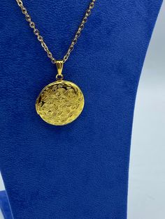 Bright Yellow Gold Round Photo Locket in a Detailed Floral Design complete with Necklace.  The traditional 'keepsake' locket was made popular in the Renaissance period and usually contained a miniature portrait. By the late Eighteenth Century and with the beginning of photography the locket became an increasingly popular wedding gift.  A lovely locket to keep your memories close to your heart.  Details:  Apx measurements External - 26mm diameter, Internal, to hold a photo - 20mm diameter. Detailed Etched Floral Pattern on the Front, back is plain.  It's made of Stainless Steel with a 14kt gold alloy plating giving it a bright yellow gold finish.  The chain is made from a brass alloy with 14kt Gold Alloy Plating and is 450mm, 45cm in length.. If you would like a photo fitted I can do this f Formal Spiritual Jewelry With Adjustable Chain, Spiritual Jewelry With Adjustable Chain For Formal Events, Gold Jewelry With Detachable Pendant For Gift, Gold Jewelry With Detachable Pendant As Gift, Gold Medallion Locket Necklace With Filigree, Gift Jewelry With Detachable Round Pendant, Detachable Round Pendant Jewelry Gift, Gold Pendant Locket Necklace As A Gift, Gold Pendant Locket Necklace For Gift