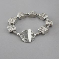 "Beautiful handmade artisan fine silver beads encircle your wrist and close with a handmade sterling silver toggle clasp. All metal is solid .925 - .970 sterling and fine silver. Silver Box beads - 1/2\" long Toggle Clasp - slightly over 3/4\" in diameter Length - approx. 7 1/8\" long View more items in my shop here: http://www.etsy.com/shop/DJStrang?ref=si_shop Item ships insured 1st Class Mail within 48 hours of cleared payment, excluding weekends and holidays." Adjustable Silver Beads Jewelry With Unique Style, Adjustable Silver Beads Fusion Jewelry, Adjustable Fusion Style Silver Beaded Jewelry, Adjustable Artisan Sterling Silver Beaded Bracelets, Adjustable Sterling Silver Beaded Fusion Bracelets, Silver Round Bohemian Beaded Bracelets, Adjustable Silver Beaded Fusion Bracelet, Bohemian Silver Beaded Round Bracelets, Handmade Sterling Silver Beaded Bracelets