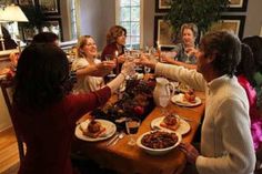 a group of women toasting at a dinner table