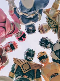 a group of people wearing helmets standing in the middle of a circle with their hands together