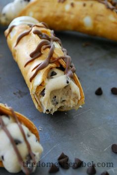 two chocolate chip banana split sandwiches on a baking sheet with one broken in half and the other partially eaten