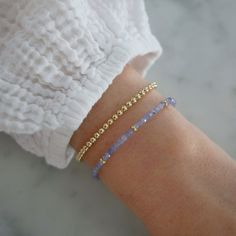 Add a special touch to your look. Our Birthstone Bead Collection styles are crafted with natural stones and three 14k gold rondelles strung on a coated wire for maximum durability. Wear your own birthstone—or a loved one’s—for a meaningful layer in any bracelet stack. Tanzanite is December's birthstone. Beaded Stacking Bracelets, Birthstone Beaded Bracelets, 14k Gold-filled Yellow Gold Beaded Bracelets, Everyday Jewelry With Faceted Beads In 14k Gold Filled, Minimalist Hand-strung 14k Gold Filled Beaded Bracelets, Minimalist Hand-strung Beaded Bracelets In 14k Gold Filled, Delicate Adjustable 14k Gold Beaded Bracelet, Adjustable 14k Gold Beaded Bracelets With Tiny Beads, Adjustable Delicate 14k Gold Beaded Bracelet