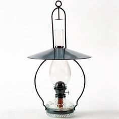 an old fashioned lamp with a light bulb on it's side and a wire hanging from the top