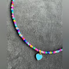 Colorful Spring/Summer Necklace! 16” Length. Handmade With 3mm Seed Beads On Jewelry Wire To Maintain Shape. Blue Enamel Heart Pendant And 18k Gold-Plated Lobster Clasp. Blue Heart-shaped Jewelry With Colorful Beads, Adjustable Blue Heart-shaped Beaded Necklaces, Adjustable Blue Heart-shaped Beaded Necklace, Adjustable Blue Heart Beaded Necklaces, Blue Adjustable Heart-shaped Beaded Necklaces, Heart-shaped Colorful Beads Jewelry For Beach, Adjustable Blue Beaded Necklace With Heart Beads, Blue Heart Beads Jewelry For Festivals, Blue Beaded Necklaces With Letter Beads For Festivals