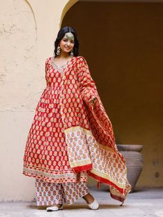 Red Angrakha Anarkali Kurti with palazzo and chanderi dupatta, has a v-neck and full-length sleeves, embellished with hand block printing work all over. Neck: Angarakha Neck Sleeve Length: 3/4th Sleeve Kurta Length: Ankle Length Fabric: Kurta & Bottom - Cotton Dupatta - Chanderi Note: Wash Care Instructions - Dry Clean Only. The product will be shipped within 15-20 days of the order placed Measurements: Size Bust Waist Hip XS 34 28 36 Size 36 30 38 M 38 32 40 L 40 34 42 XL 42 36 44 2XL 44 38 46 Red Cotton Silk Bollywood Kurta, Red Bollywood Cotton Silk Kurta, Red Bollywood Style Cotton Silk Churidar, Anarkali Palazzo Set With Zari Work And Long Sleeves, Traditional Red Cotton Silk Sharara, Red Traditional Cotton Silk Sharara, Bollywood Style Red Cotton Silk Sharara, Festive Chanderi Salwar Kameez With V-neck, Long Sleeve Anarkali Set With Gota Work For Navratri