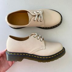 Brand: Dr. Martens Size: Women’s Size 6 Condition: New Without Tags Colors: Beige Or Cream Description: "Neutral Summer Tones Worn In From The First Step, So You Can Make The Most Of The Longer Days. We've Built Our Original 1461 3-Eye Shoe Using Soft, Pebbled Virginia Leather. The Shoe Is Made As It Has Been Since The 60s: Welted On A Translucent Grooved Dms Outsole And Secured With Our Signature Yellow Welt Stitching. Each Shoe Is Detailed With A Bitter Choc Welt And Antique Gold Eyelets. In A 1461 Women's Virginia Leather Oxford Shoes, Beige Round Toe Oxfords For Spring, Casual Cream Leather Shoes With Round Toe, Classic Beige Lace-up Shoes With Rubber Sole, Beige Lace-up Shoes With Stitched Sole For Spring, Cream Lace-up Shoes With Rubber Sole, Beige Oxfords With Stitched Sole And Round Toe, Cream Leather Lace-up Shoes For Spring, Beige Almond Toe Oxfords With Stitched Sole