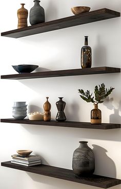 three wooden shelves with vases and bowls on them