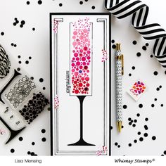 a card with a wine glass on it next to some tape and other crafting supplies