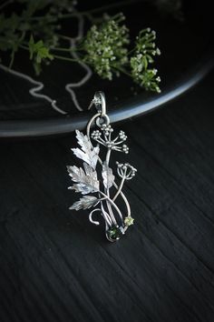 ITEM DESCRIPTION: The size H 5 cm x W 3 cm (2 x 1 1/3 inch). Weight - 5 g. You can buy it with a silver chain or without it. Even simple plants look very elegant. I made one of sterling silver, pretty green tourmaline, and peridot. This unique botanical jewelry looks like a real treasure of wild forest. It is really worthy of being in your precious collection. Expect many compliments on this! This handmade necklace will come to you in a gift box - ready for gifting. The parcel will be sent durin Green Sterling Silver Flower Pendant Jewelry, Silver Nature-inspired Round Pendant Jewelry, Silver Round Pendant Jewelry With Nature-inspired Style, Nature-inspired Metal Pendant Necklace, Nature-inspired Sterling Silver Pendant Jewelry, Nature-inspired Sterling Silver Pendant Necklace, Nature-inspired Sterling Silver Leaf Necklace, Nature-inspired Leaf Shaped Sterling Silver Necklace, Nature-inspired Sterling Silver Jewelry With Large Pendant