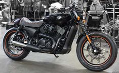 a black and orange motorcycle parked in a garage