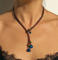 "Lariat necklace, leather necklace, stone necklace, necklace for woman belong to bohemian jewelry as well as boho jewelry. A gemstone jewelry piece carefully designed and crafted by EndiaDesign. Show off a bohemian style with this unique leather necklace made of high quality cow leather, agates stones in blue colour and a beads in antique bronze tone. You could wear this original gemstone necklace on any occasion, formal or casual, making you look super chic and cute. Agate Healing Properties ♥ Bohemian Lariat Necklace With Sliding Knot, Bohemian Lariat Necklace With Adjustable Cord, Bohemian Lariat Necklace As Gift, Bohemian Lariat Necklace Choker With Adjustable Length, Bohemian Lariat Choker Necklace, Bohemian Long Lariat Necklace With Adjustable Length, Bohemian Festival Lariat Necklace With Adjustable Chain, Bohemian Lariat Necklace With Adjustable Pendant, Bohemian Brown Lariat Necklace With Adjustable Length