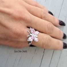 Pink CZ butterfly silver ring, clear - butterfly ring, silver ring, promise ring - 925 sterling silver Height: 16.0mm Width: 17.0mm Shank Width: 1.7mm Stone Material: Pink and White Cubic Zirconia Center Stone Size: 7.0mm x 5.0mm & 6.0mm x 4.0mm Stone Shape: Pear and Round Center Stone Carat Weight: 0.71 ct. & 0.39 ct. Number of CZ Stones: 8 Stone Setting: Prong Metal: 925 Sterling Silver Plating: Rhodium Finish: High Polish simply stunning. High Polished, solid 925 sterling silver. Rhodium plat Elegant Butterfly Ring With Cubic Zirconia For Gift, Butterfly-shaped Cubic Zirconia Wedding Rings, Butterfly Cubic Zirconia Wedding Rings, Formal Butterfly-shaped Cubic Zirconia Rings, Wedding Butterfly Ring In Cubic Zirconia, Fine Jewelry Butterfly Shape For Wedding, Elegant Butterfly Diamond Ring For Gift, Adjustable Butterfly Promise Ring, Fine Jewelry Butterfly Piece For Wedding