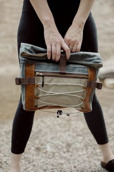 "The Denver Roll Top has it all; ample space and storage, ultimate comfort and multiple carrying options. This bag, made from waxed canvas, leather and waterproof ripstop, features cushioned hip flaps to wear around your waist or across your chest/back. It comes with a detachable, adjustable wide webbing strap to wear the bag crossbody or over the shoulder. The large front zipper pocket features shock cording to carry any additional items, like a layering shirt for hiking or a pair of gloves. Attach a carabiner to the cording and bring along doggie bags on your walk. Ripstop lining is waterproof, lightweight and super durable. Inside, you'll find two slip pockets. The Denver Roll Top has a leather base for added durability. Dimensions: 15\" wide 13.5\" tall (unrolled) 9.5\" tall (rolled) 3 Rugged Bag With Waxed Finish For Outdoor Activities, Rugged Waxed Canvas Bag For Outdoor Activities, Outdoor Waxed Finish Crossbody Shoulder Bag, Outdoor Shoulder Bag In Coated Canvas With Waxed Finish, Outdoor Leather Shoulder Saddle Bag, Outdoor Waxed Canvas Shoulder Bag With Zipper Pocket, Canvas Bag With Removable Pouch For Outdoor Activities, Canvas Bags With Removable Pouch For Outdoor Activities, Practical Outdoor Shoulder Bag With Waxed Finish