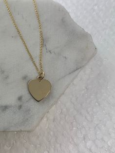 "This sweet and simple Gold heart pendant can be engraved on both sides.  - 14K Solid Gold  - Available in Rose Gold, Yellow Gold, White  Gold  - Gold Heart Measures 12MM height / 11MM wide  - Adjustable Length: 14\" - 15\" - 16\"  All our materials and jewelry are sourced ethically and responsibly.  Our jewelry is complimentary gift wrapped in our signature Willow Roe boxes." Minimalist Tarnish Resistant 14k Gold Heart Necklace, 14k Gold Necklace With Heart Charm And Cut, 14k Gold Charm Necklace With Heart Pendant, Gold Engraved Heart Pendant Necklace, Minimalist Silver Heart Necklace In 14k Gold, 14k Gold Heart Charm Necklace With Round Pendant, 14k Gold Heart Charm Necklace For Her, 14k Gold Heart Charm Necklace As Gift For Her, Classic 14k Gold Heart Pendant Necklace