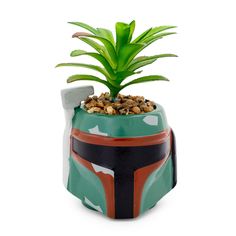 PRICES MAY VARY. AS YOU WISH: When navigating the galaxyâ€s gritty underworld, you're going to want to gear up. The iconic bounty hunter Boba Fett has arrived in the form of this exclusive mini planter inspired by his original appearance in Star Wars. THE FEARSOME LEGEND OF THE UNDERWORLD: 3D sculpted planter features Boba Fett's green Mandalorian helmet with a realistic succulent sprouting out of the top. Sculpted from a durable ceramic mold complete with a glossy finish. A BOUNTY WORTH TRACKIN Small Ceramic Planter, Boba Fett Helmet, Star Wars Decor, Small Flower Pots, Ceramic Molds, Artificial Succulents, Star Wars Fandom, Decorative Planters, Faux Succulents