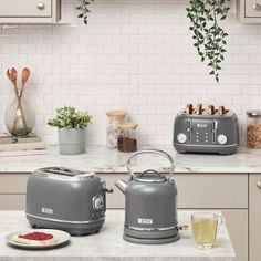 two toasters sitting on top of a kitchen counter