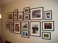 a wall with many pictures hanging on it