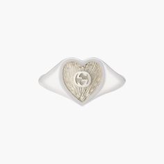 Sterling silver Gucci heart signet ring with white mother-of-pearl enamel. In the center of the Enamel the interlocking G logos is raised. The top of the ring is 0.04" in size. Mother Of Pearl Signet Ring, Gucci Sterling Silver Ring For Formal Occasions, Classic Gucci Engraved White Gold Ring, Classic Gucci Engraved Ring For Anniversary, Classic Gucci Engraved Ring For Gift, Classic Gucci Engraved Ring As Gift, Gucci White Gold Ring In Fine Jewelry Style, Gucci Fine Jewelry White Gold Rings, Gucci White Gold Fine Jewelry Ring