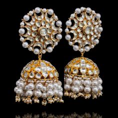 Radiant sheer elegance with this showstopper worthy set- inspired by Aiman Khan's stunning grace at Minal Khan's wedding! Stunning jhumkey earrings and a maang teekah set with a classic combination of kundan stones and pearl moti. Approximate earrings length is 3.25". Gold-plated on high-quality brass as base metal. Made by order. Kindly allow 5-7 weeks for the delivery of this item. For custom or urgent requests, please contact support@alacouture.com. *Please Note: We use faux stones and beads Wedding Jhumkas With Intricate Design For Diwali, Elegant Kundan Jhumkas With Gota Work, Bollywood Style Intricate Design Jhumkas For Wedding, Bollywood Style Intricate Design Wedding Jhumkas, Bollywood Style Wedding Jhumkas With Intricate Design, Elegant Festive Anarkali Set With Tilla, Reception Kundan Danglers With Cutdana Details, Kundan Cutdana Danglers For Reception, Elegant Kundan Bridal Earrings With Cutdana