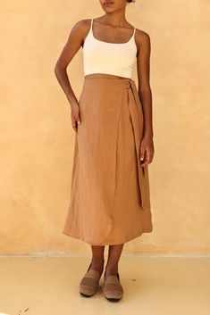 Linen wrap skirt has a side tie for easy adjustment, making it comfortable and versatile for any fit. Handcrafted in our studio to your measurements and preferences, available in over 60 colors. STYLE DETAILS - 100 % linen, medium weight (200gsm), free-shrinkage, amazingly soft feel - High waisted - Wrap skirt with woven tie - Inseam pockets - Below mid-calf length 30''/75cm/size S for our lovely model 5ft5/169cm tall. - Custom made skirt, FREE customizations; simply let us know your needs - Han Flowy Wrap Skirt With Tie Waist, Relaxed Midi Wrap Skirt With Tie Waist, Casual Linen Wrap Skirt For Spring, Beige Linen Skirt For Day Out, Flared Linen Wrap Skirt For Summer, Casual Asymmetrical Linen Skirt, Spring Linen Wrap Bottoms, Beach Linen Flared Skirt, Casual Linen Asymmetrical Skirt