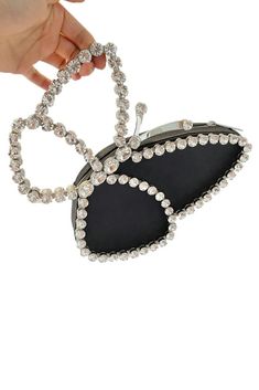 Elevate your style with our Black Butterfly Clutch, adorned with dazzling crystals. This exquisite accessory adds a touch of sophistication to any ensemble, perfect for glamorous evenings, cocktail parties, and formal affairs. Trendy Evening Jewelry With Rhinestones, Trendy Crystal Jewelry For Party, Elegant Evening Crystal Jewelry, Elegant Evening Holiday Jewelry, Elegant Holiday Party Jewelry, Chic Bling Jewelry For Night Out, Chic Crystal Jewelry For Evening, Chic Silver Evening Jewelry, Elegant Rhinestone Jewelry For Party