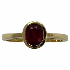 Main Stone Creation: Natural Sizable?: Yes Cut Grade: Very Good Sizable: Yes Main Stone Colour: Red Metal: Yellow Gold Total Carat Weight: 0.75 ctw - 0.99 ctw Main Stone: Ruby Colour: Red Setting Style: Bezel Brand: GemsandJewelsUK Ring Size: P 1/2 Type: Ring Metal Purity: 18Carat Main Stone Shape: Oval Total Carat Weight (TCW): 0.75 Country/Region of Manufacture: United Kingdom Fine Vivid Red Ruby 18 Karat Yellow Gold Solitaire Ring. Stunning 0.75 carat ruby with a fine vivid red colour and excellent oval cut. Also has very good clarity with only some small natural inclusions visible when looking closely. The ruby is set in a fine 18k yellow gold bezel/rubover solitaire setting. Ring size P1/2. The ring is re-sizeable. Brand new and never worn. Fully hallmarked by Birmingham Assay Office Gold Ruby Ring Oval Cabochon With Polished Finish, Red Ruby Oval Cabochon Ring In 14k Gold, 14k Gold Polished Oval Cabochon Ruby Ring, Red Ruby Rings In Oval Cabochon Shape, Red Diamond Ring, Ruby Ring Designs, Emerald Cut Solitaire Ring, Classic Red Ruby Ring, Oval Cabochon, Yellow Gold Solitaire Ring