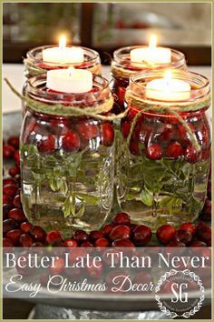 two mason jars filled with cherries and candles