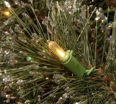 a close up of a christmas tree with some lights on it