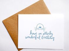 a card with the words have an otterly wonderful birthday written on it and a seal in blue ink