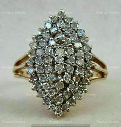 a diamond cluster ring on a white surface