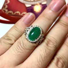 MADE TO ORDER ONLY! 1 week gold crafting period. EXTREMELY VIVID, Certified 7.57 carats, COLOMBIAN Emerald ring. SUGGESTED RETAIL VALUE: $18,000 EMERALD: Weight: 6.63 carats Shape: Oval Cabochon Dimensions: 9.27 x 14.73 x 5.90 mm Color: Green Origin: COLOMBIAN NATURAL EMERALD WITH OIL TREATED ONLY (F3) Gemological certificate provided as shown. TRANSPARENT EXTREMELY CLEAN EXCELLENT COLOR AND CUT! RARE VIVID, COLOMBIAN, BLUISH-GREEN COLOR!! DIAMONDS: 50 round brilliant diamonds weighting a total Colombian Emerald Ring, Handmade Gold Ring, Vvs Diamond, Colombian Emeralds, Bluish Green, Natural Emerald, Emerald Ring, Oval Cabochon, Solitaire Ring