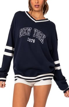 Enjoy Big Apple energy in this varsity sweater designed with dropped shoulders and contrasting stripes. V-neck Long sleeves Ribbed cuffs and hem 100% acrylic Hand wash, dry flat Imported New York Sweater, New York Sweatshirt, Varsity Sweater, Oversized Sweater Women, Collar Cardigan, Cardigan Vest, Warm Coat, Sweater Design, Knit Pants