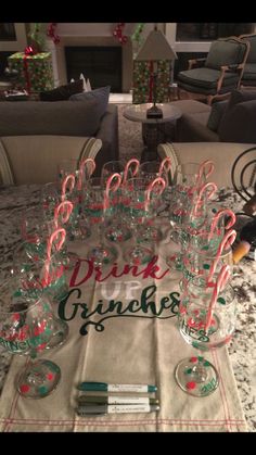 a table topped with lots of glasses and candy canes on top of a table