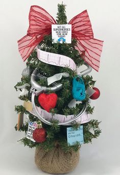 a small christmas tree decorated with ribbon and items