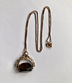 Attractive pre loved solid 9k gold spinning Smokey quartz fob and fine box link 17 inch long chain. CONDITION: Very good  FOB SIZE 20mm x 25mm CHAIN LENGTH: 17 inches ( 43.18cm long ) This necklace has a 9ct gold hallmark on it ( 375 gold ) but in addition has been professionally checked, cleaned and polished. Comes in a new box. Smokey Quartz, Long Chain, Chain Lengths, Chain Length, Gold Chain, Gold Chains, Hallmark, Spinning, Jewelry Necklace Pendant