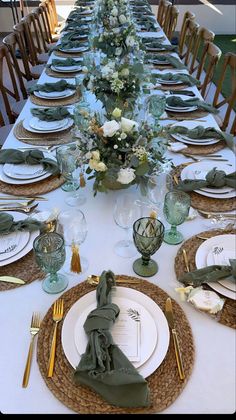 the table is set with plates and place settings