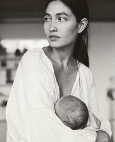 a woman holding a baby in her arms