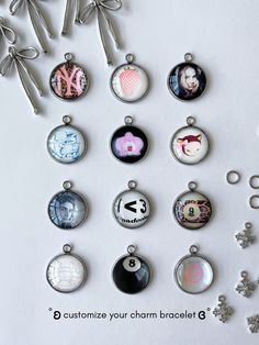 a bunch of different types of charms on a white surface with scissors and snowflakes