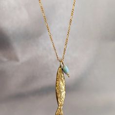 Necklace Details: The Necklace And The Pendant Made From 14 Karats Solid Yellow Gold. Chain Length 20inch/ 50cm'. Fish Pendant Size: 1.3x0.25inch/ 33x6mm. A Goldfish Necklace With The Good Eye Stone That Will Lead Us On The Right Path . Chain Available In All Sizes, Color Gold And Karat And Matte Or Shining Finish. Each Pendant Is Custom-Made, Unique, And Will Have Slight Variations In Shape. If You Want To Change Something, Width, Length, Personal Engraving, Or Anything Else. Please Contact Me. Gold Fish-shaped Necklace For Gift, Elegant Yellow Gold Fish Shaped Necklace, Goldfish Necklace, Gold Fish Necklace, Fish Necklace, Fish Pendant, Gold Fish, Eye Stone, Custom Necklace