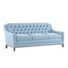 a blue couch sitting on top of a white floor