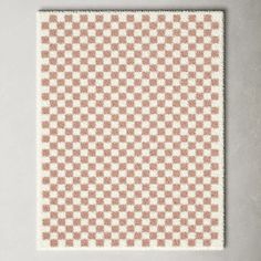 a white and brown checkerboard pattern on a wall with a light gray background