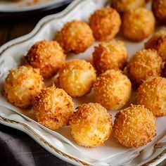 some fried food is on a plate and ready to be eaten with other foods in the background