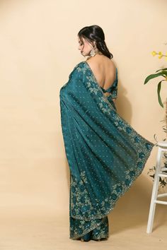 Expertly crafted teal blue zardozi saree with stonework and floral embroidery. Perfect for any special occasion, this traditional Indian piece exudes elegance and luxury. Timeless design and comfortable fit. Zardosi Saree, Zardozi Saree, Baluchari Saree, Golden Saree, White Embroidered Blouse, Orange Saree, Net Blouses, Cotton Gowns, Crepe Saree