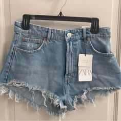 Brand New, Never Worn High Rise Denim Cut Offs From Zara Spring High Waist Tops With Frayed Hem, High Waist Cotton Tops With Frayed Hem, Light Wash Denim Crop Top, Light Wash Denim Short Tops, Light Wash Denim Top In Short Length, Light Wash Short Denim Top, Denim Blue High Waist Top For Summer, Casual Denim Cutoff Tops, Casual Short Denim Tops For Spring