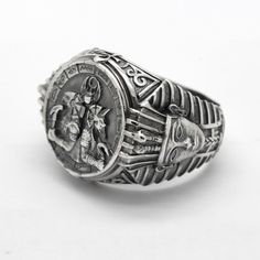 an antique silver ring with the image of jesus on it