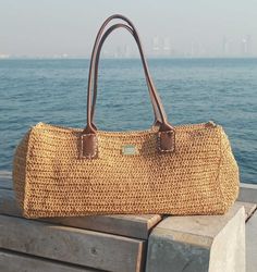 this beautful handmade bag is crocheted from %100 raffia in natural tone  and its very lightweight. Bohemian Satchel For Vacation With Large Capacity, Bohemian Satchel With Large Capacity For Vacation, Bohemian Large Capacity Satchel For Vacation, Bohemian Satchel Straw Bag With Large Capacity, Chic Jute Crochet Bag With Leather Handles, Chic Crochet Jute Bag With Leather Handles, Beige Crochet Satchel Bag For Travel, Beige Crochet Shoulder Bag For Travel, Bohemian Handheld Straw Bag With Large Capacity