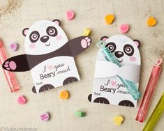 two paper pandas are next to some candy