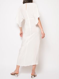 Crafted from 100% silk, the Katherine Maxi Dress features an empire waistline, a plunging neckline with a discreet hook and eye closure, half kimono sleeves, and an elegant wrap skirt. This chic silhouette is ideal for weddings, cocktail parties, and more. Note: We can also make it in off white / ivory / champagne The price $695.00 is for the light weight silk. Price will depend upon the weight of the silk, contact us for more information we can also send swatches. info@jalineresort.com Jaline i Spring Pre-draped V-neck Maxi Dress, Elegant Maxi Length V-neck Dress For Brunch, Silk V-neck Summer Cocktail Dress, Elegant Short Sleeve V-neck Dress For Brunch, Elegant V-neck Kimono For Wedding, Elegant V-neck Wedding Kimono, Pre-draped V-neck Silk Dress, Silk Wrap Dress With Surplice Neckline For Cocktail, Elegant White V-neck Kaftan